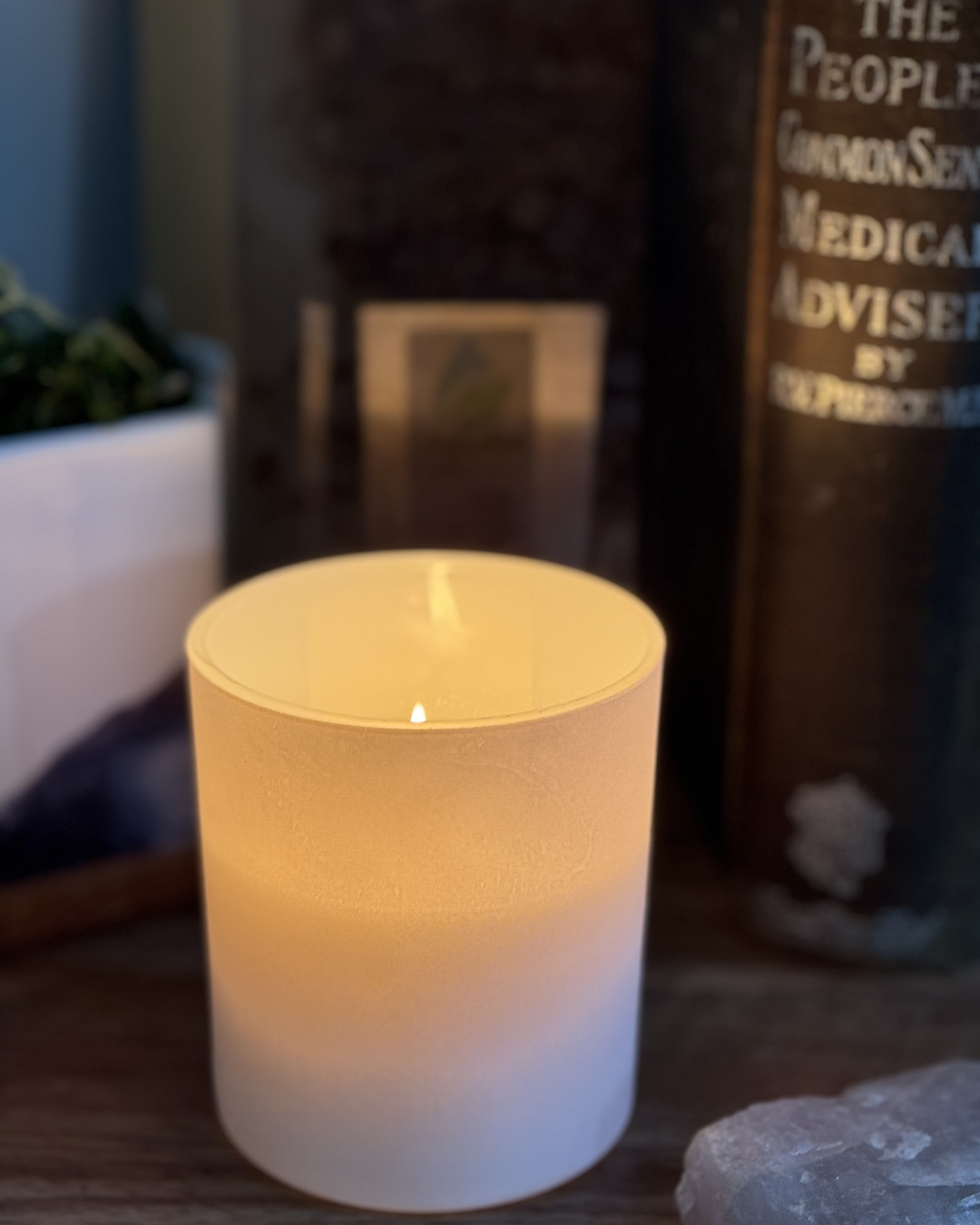 Soft candlelight creating a calm, restorative ritual atmosphere”Softly glowing candle in a frosted glass jar, casting a warm, calming light that creates a peaceful, restorative atmosphere.